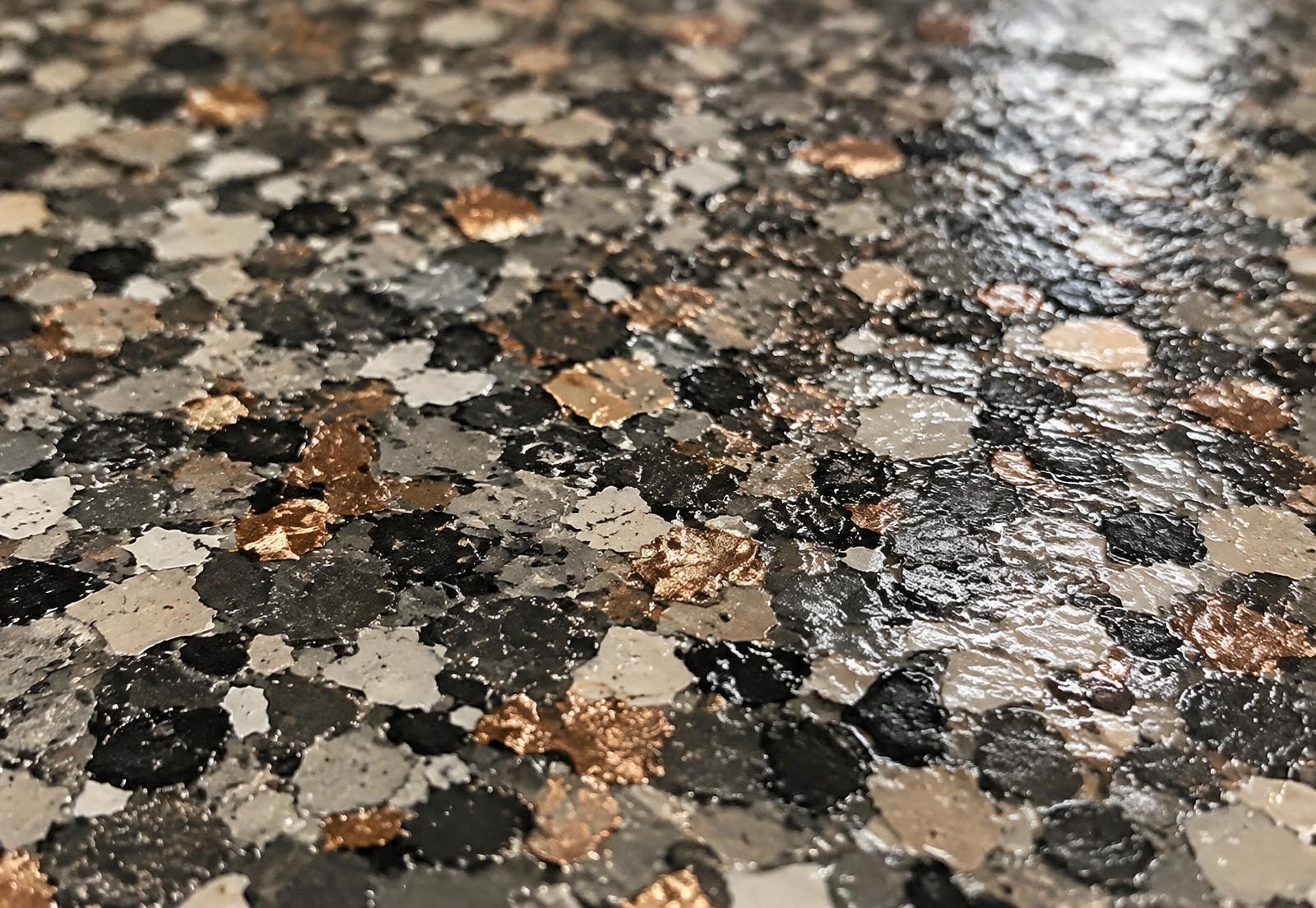 Close-up of a glossy flake coating surface in charcoal, stone and copper tones